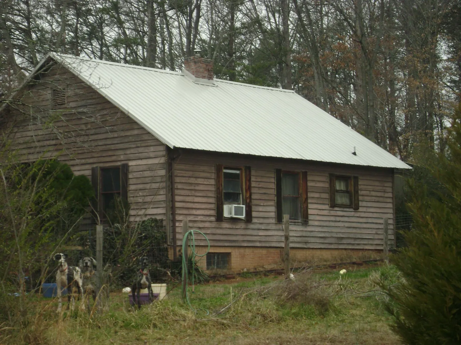 White metal roof on an old wood sided farmhouse, from a Metal Roof Installation job in Bell Gardens